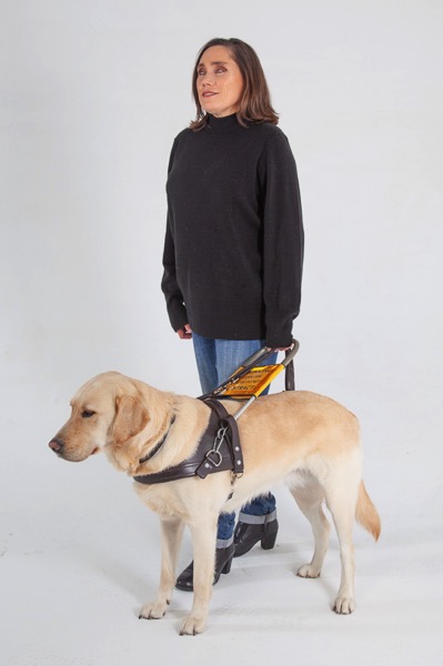 The image shows Lois walking with guide dog Fiji