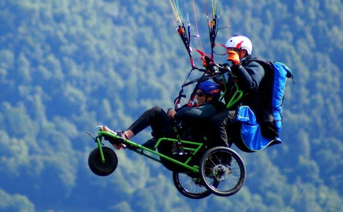 The image shows an  adaptive paraglider