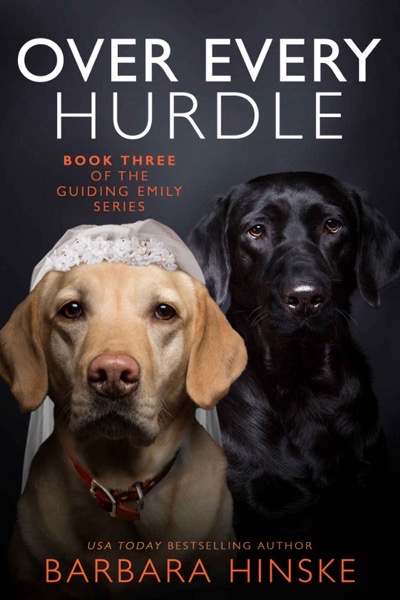 The cover of Barbara Hinske’s book Over Every Hurdle, with two Labrador retrievers, one yellow and one black. The background is dark, the yellow Lab is wearing a white bridal veil with beaded embellishments, and the black Lab is looking directly at the camera. The title and author's name are written in white and red.