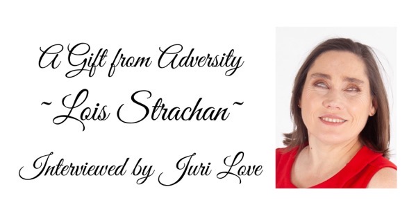 On the left side, there is text in elegant, cursive font that reads A Gift from Adversity ~ Lois Strachan ~ Interviewed by Juri Love. On the right side, there is a photo of a woman with medium-length brown hair, wearing a red top. She is smiling with her head slightly tilted upwards and to the right. The background is plain white.