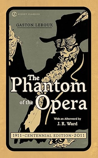 Cover of the book The Phantom of the Opera, by Gaston Leroux. The cover is mostly in shades of beige, black, and gold. The illustration shows a shadowy, dramatic figure in a mask and a wide-brimmed hat, with gloved hands pulling a cloak around himself.